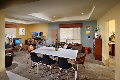 a dining room and living room with a white table and chairs